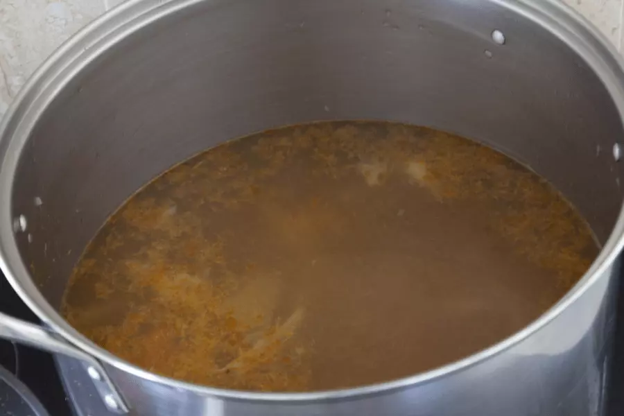 Burdock gean in a pan with a wooden spoon