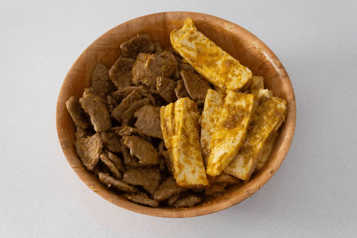 Soy protein and tofu marinating in a bowl.