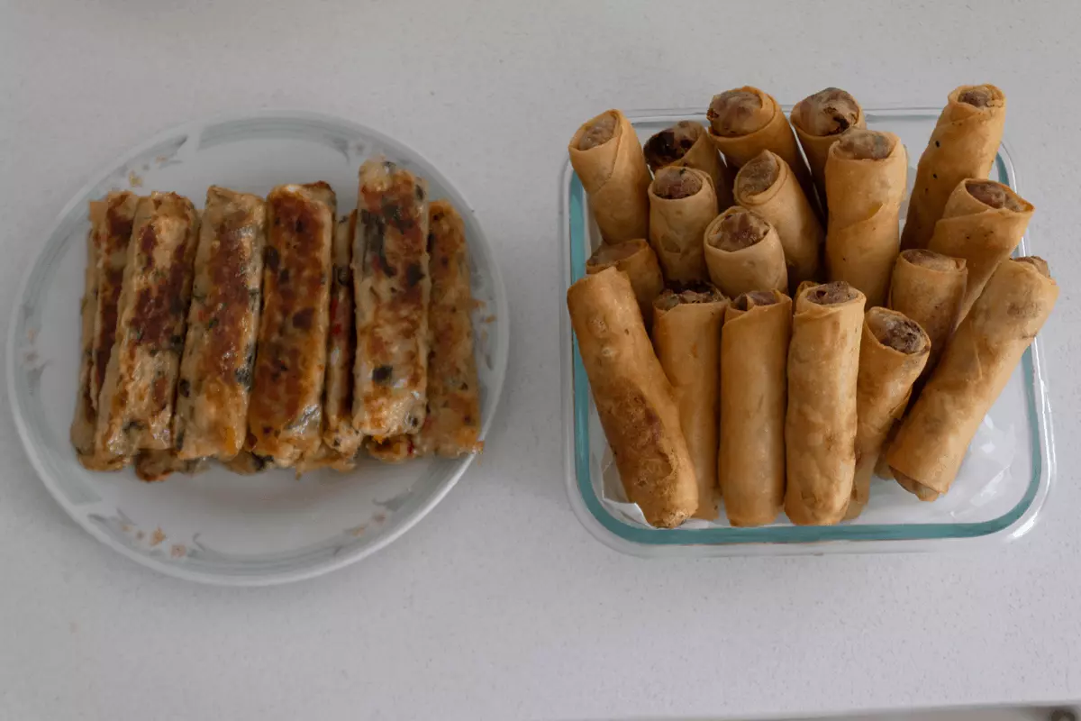 Fried vegetarian spring rolls and sugar cane prawn in dishes.